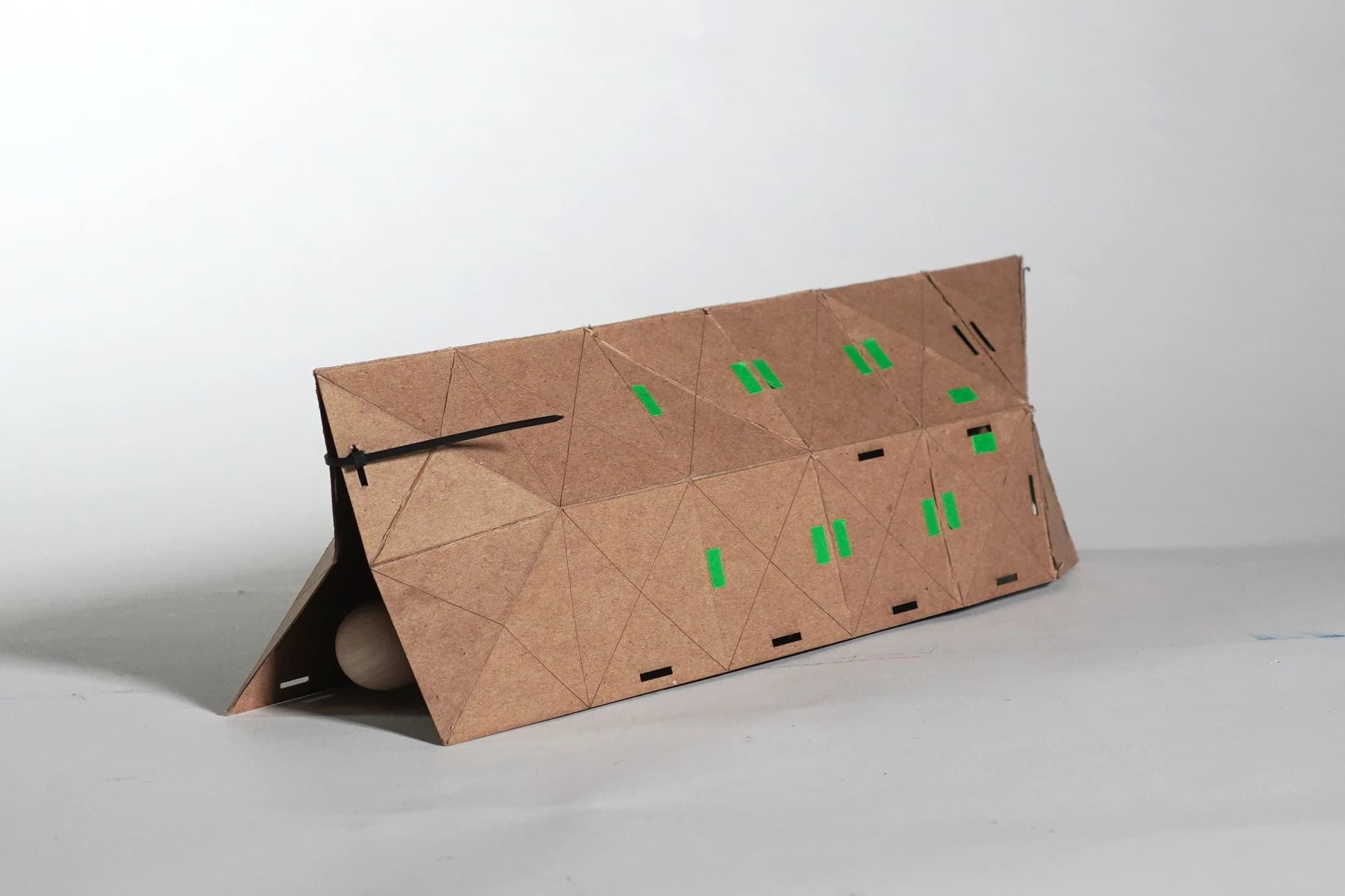 Portable shelter folded into a triangular sleeping enclosure
