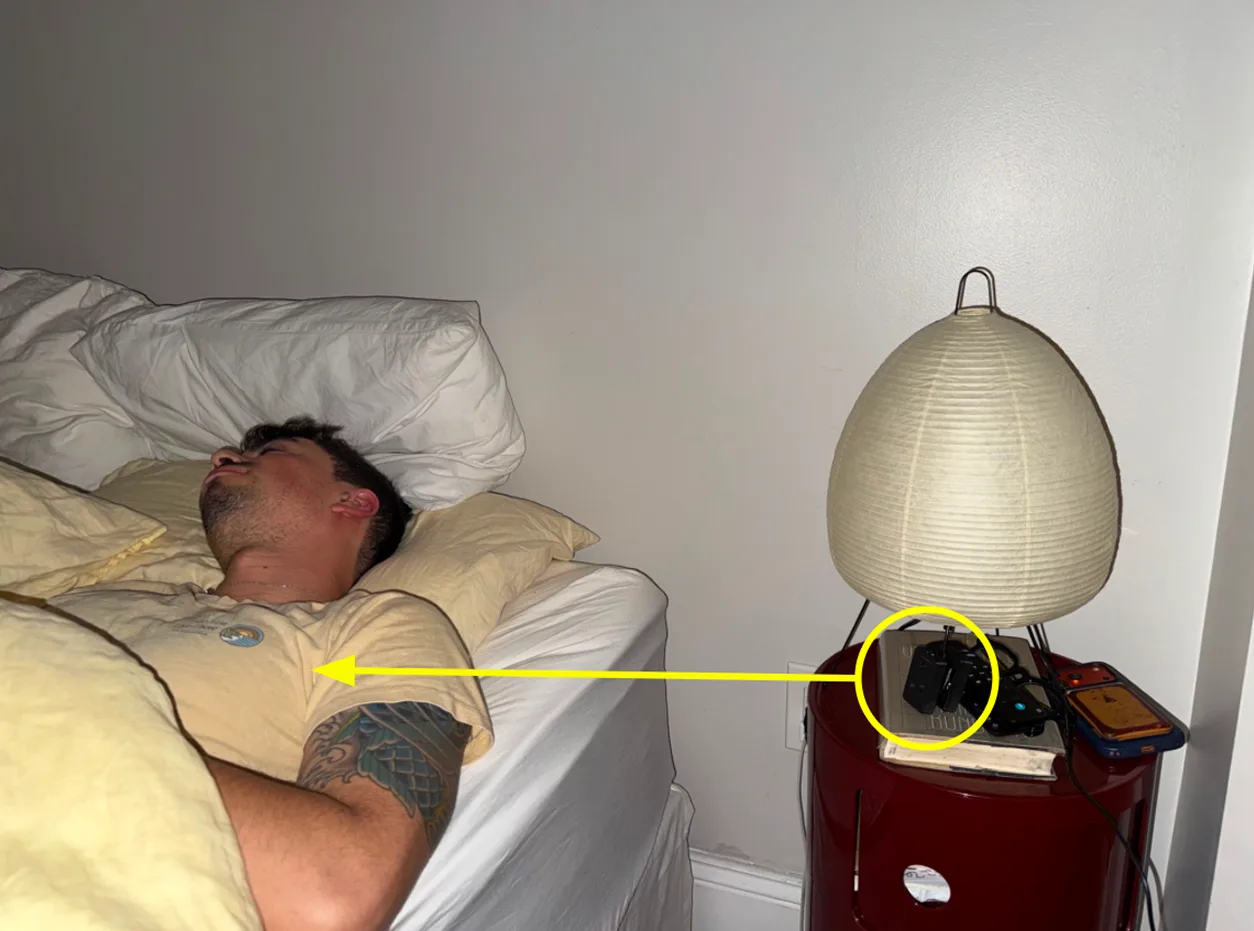 User testing: a person asleep in bed, with a prototype sensor on the bedside table aimed at them
