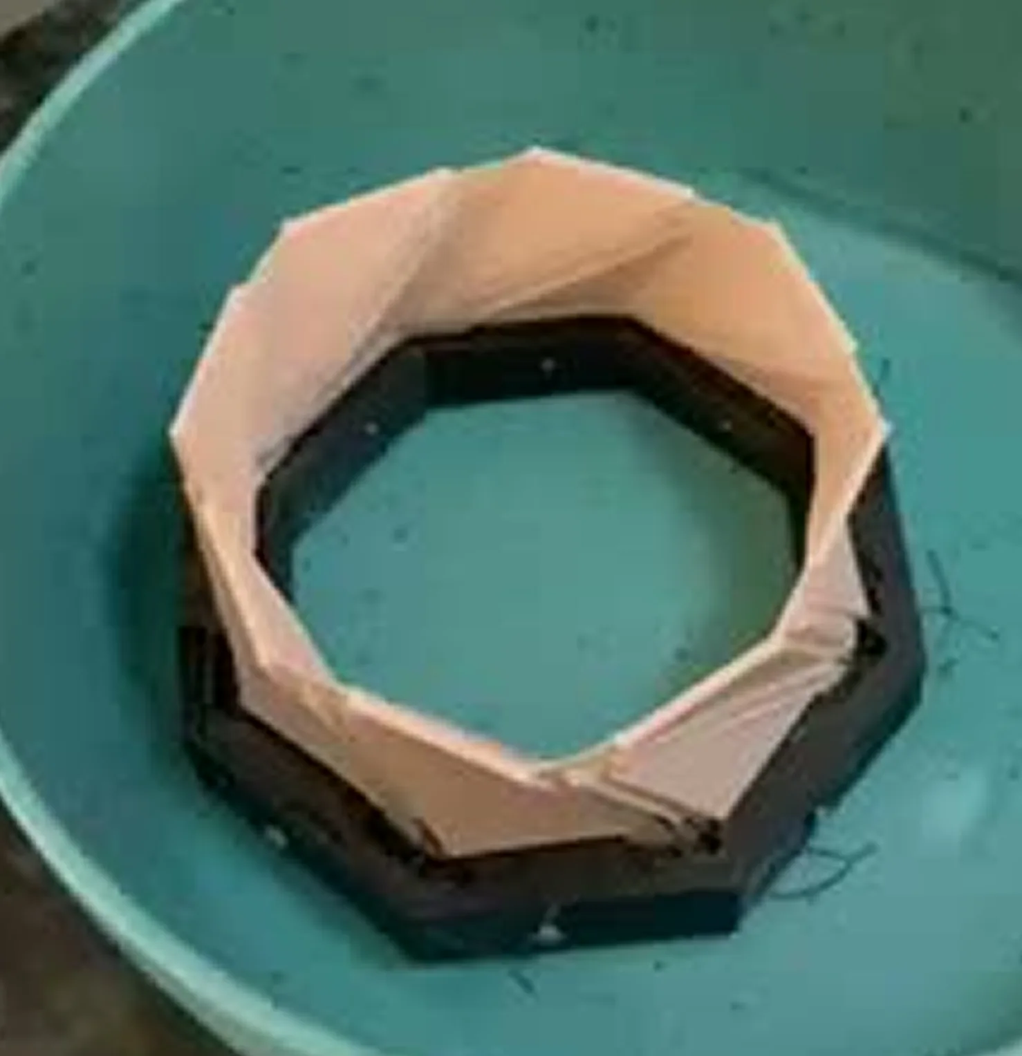The printed rim mounted on its black base, sitting in water