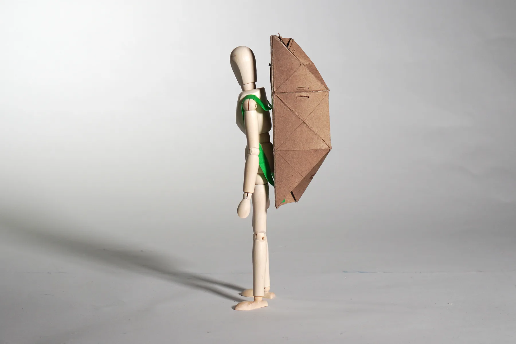 Scale figure wearing the folded shelter as a backpack